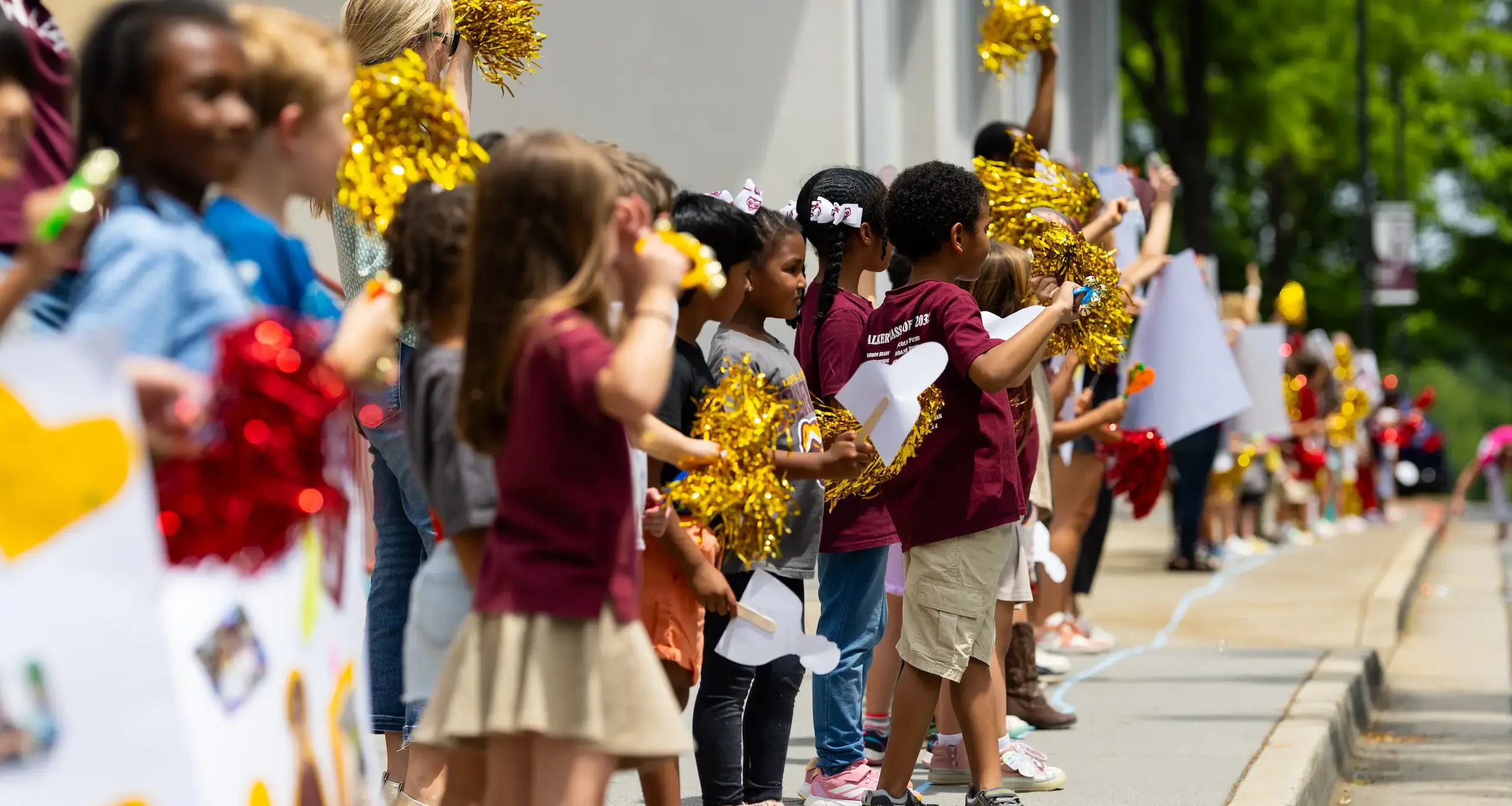 Walker senior parade with children cheering in a crowd