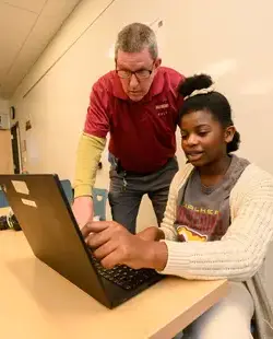 Teacher supervising student