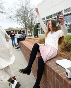 Student celebrating, holding a calculator