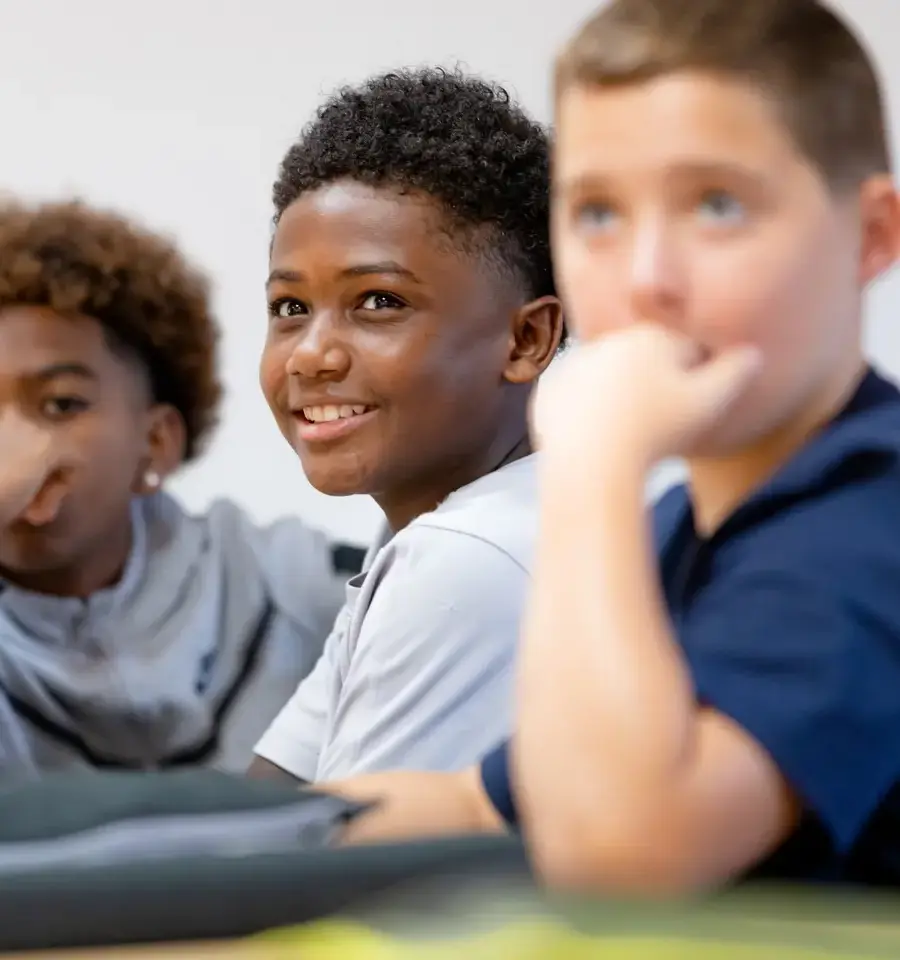 Three boys paying attention in class