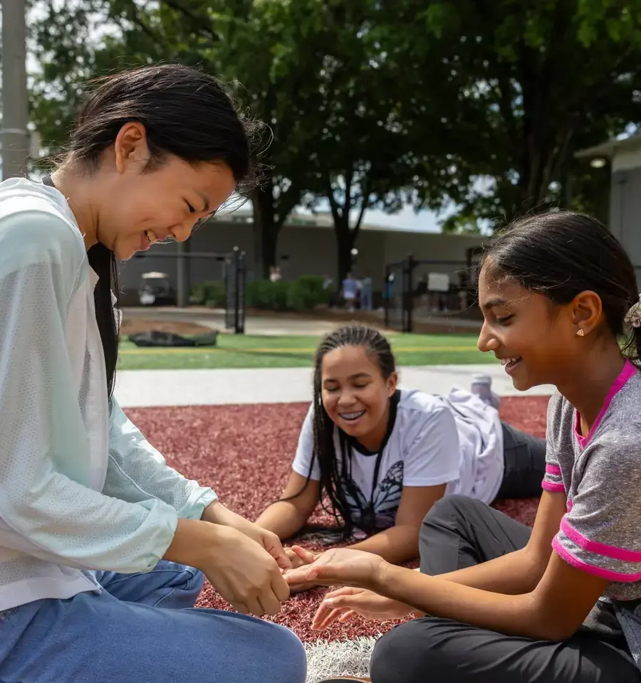 Three girls outside, chatting